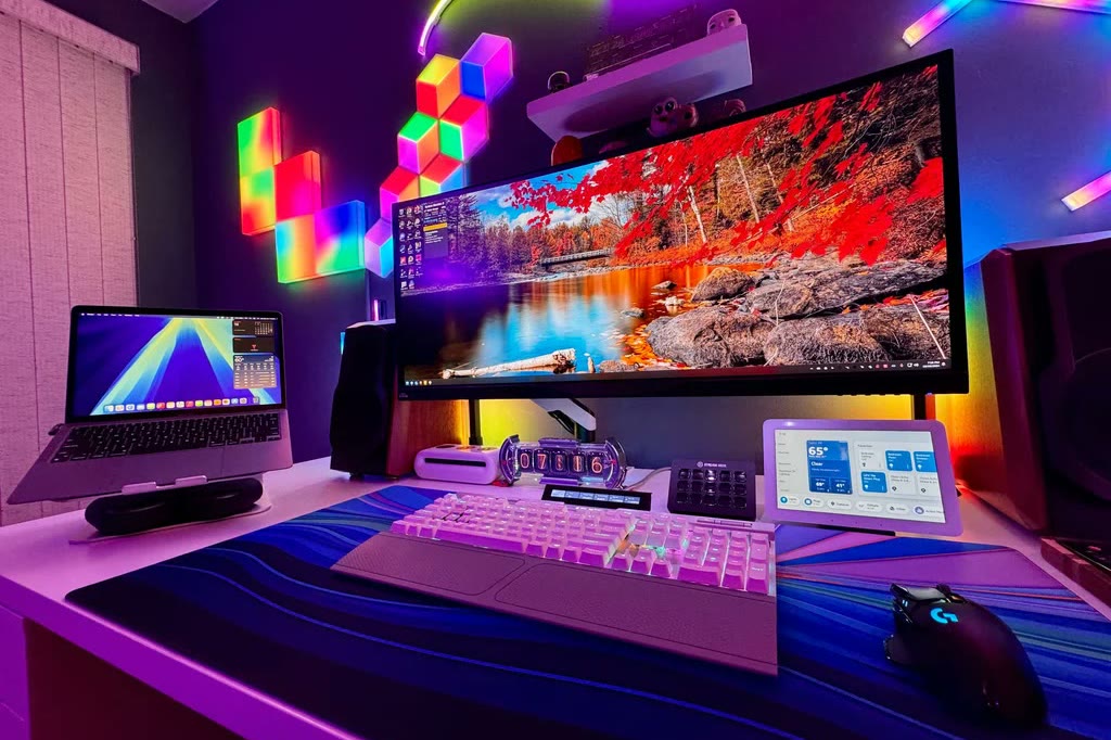 Desk with a laptop, monitor, keyboard, and mouse